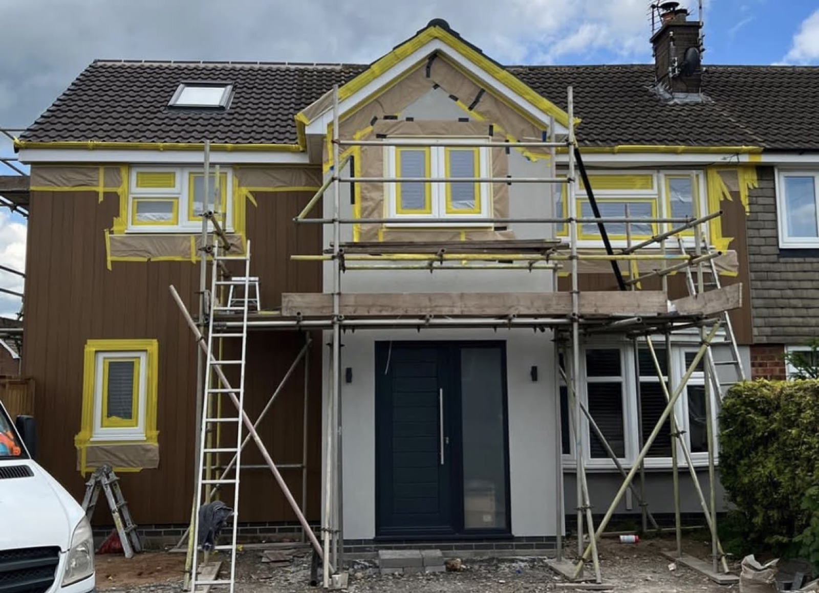 House exterior masked and scaffolded ready for spray painting