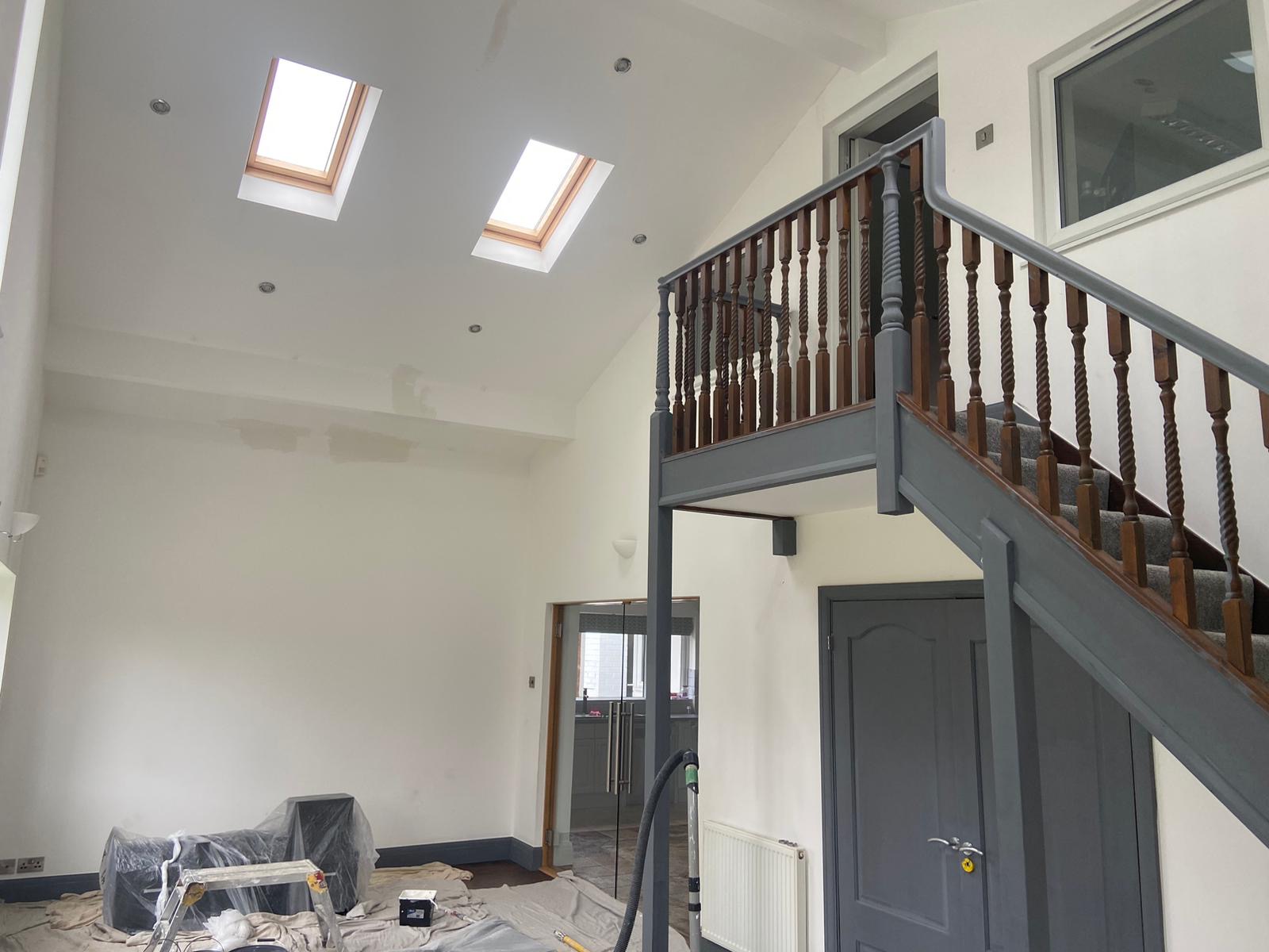 High-ceiling room protected and prepared during interior decorating